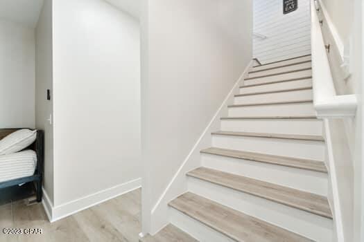 stairway with wood-type flooring