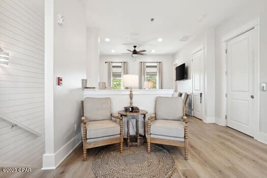 living area featuring light hardwood / wood-style flooring and ceiling fan