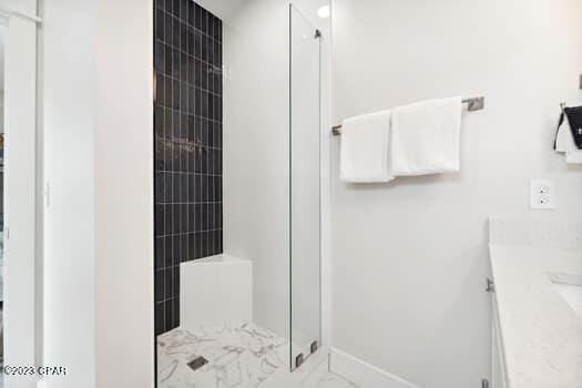 bathroom featuring vanity and a shower with shower door