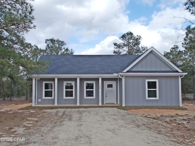 view of front of property with covered porch, a shingled roof, and board and batten siding