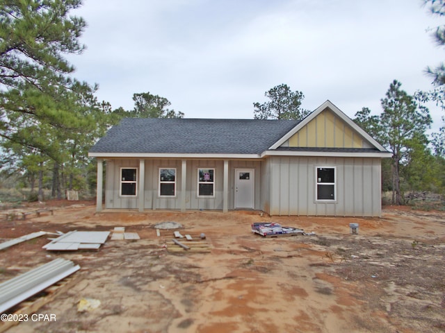 view of front of property with a shingled roof and board and batten siding