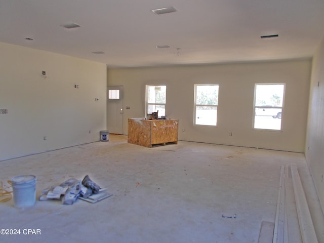 unfurnished living room with visible vents