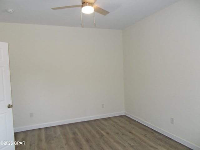 unfurnished room featuring ceiling fan, wood finished floors, and baseboards