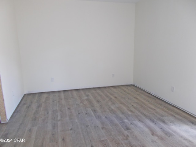 spare room featuring wood finished floors