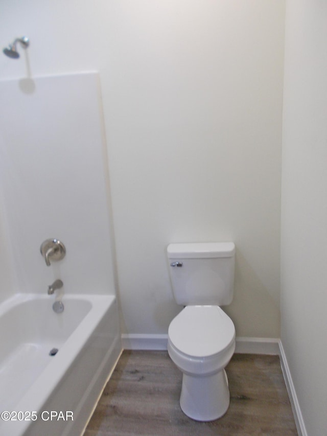 bathroom featuring wood finished floors, toilet, and baseboards