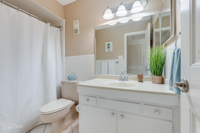 bathroom with tile patterned flooring, vanity, and toilet