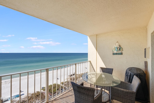 balcony with a beach view and a water view