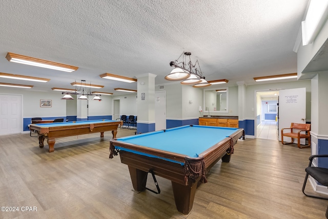 playroom featuring light wood-type flooring, a textured ceiling, and pool table