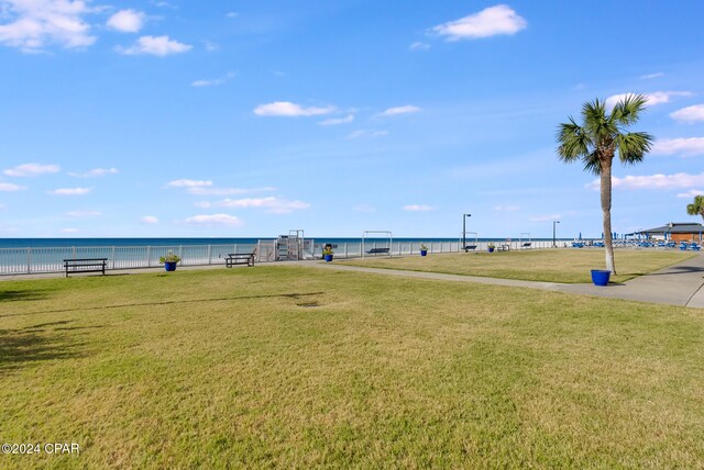 exterior space featuring a lawn and a water view