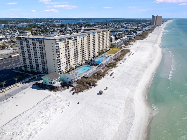 aerial view with a water view and a beach view