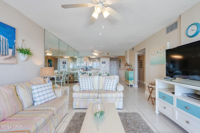 living room featuring light tile patterned floors and a textured ceiling