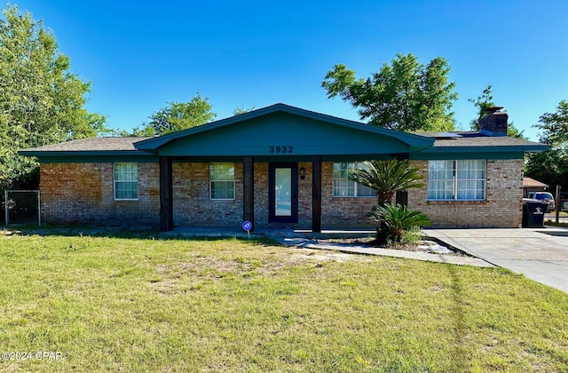 ranch-style home with a porch and a front yard