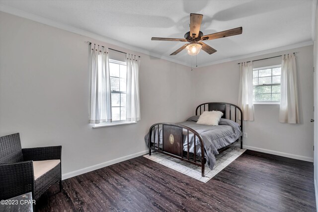 bedroom featuring ornamental molding, ceiling fan, and dark wood-type flooring