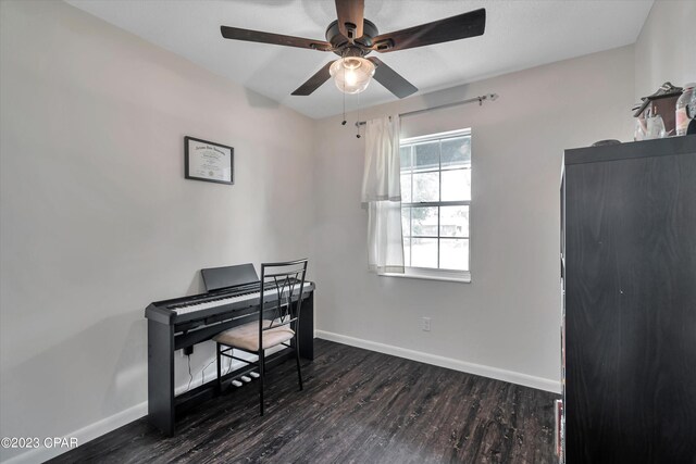 home office with ceiling fan and dark wood-type flooring