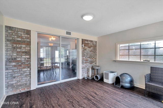 unfurnished room with wood-type flooring and a healthy amount of sunlight