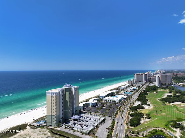 drone / aerial view featuring a water view and a beach view