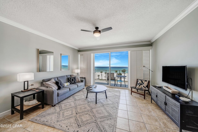 tiled living room featuring a textured ceiling, ornamental molding, and ceiling fan