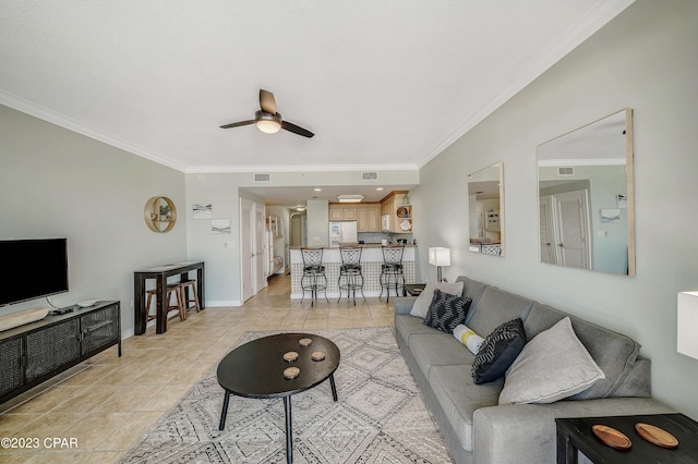 tiled living room with ornamental molding and ceiling fan