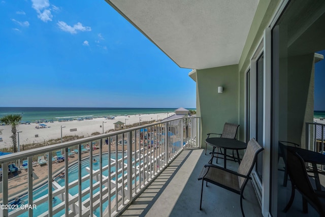 balcony with a view of the beach and a water view