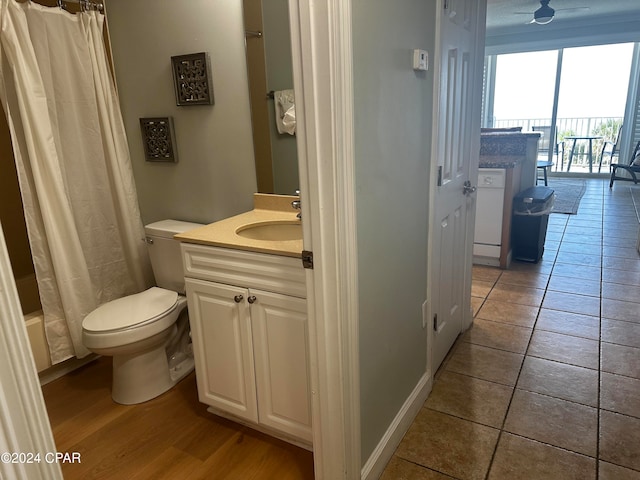 bathroom with tile patterned flooring, vanity, toilet, and a shower with shower curtain