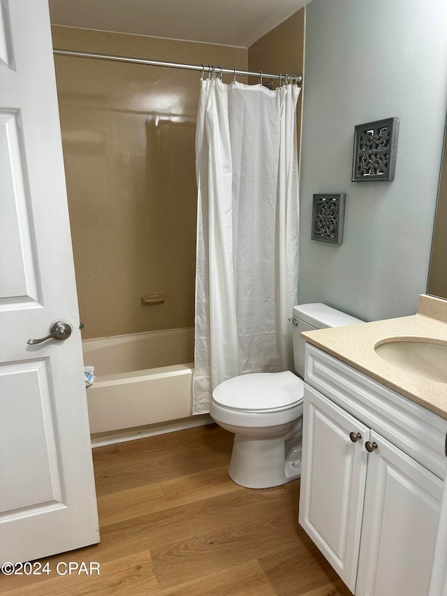 full bathroom featuring vanity, toilet, shower / bathtub combination with curtain, and hardwood / wood-style flooring