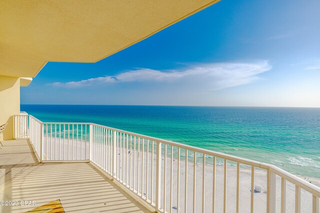 balcony with a view of the beach and a water view