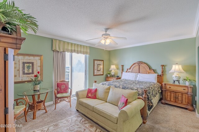 carpeted bedroom featuring ornamental molding, ceiling fan, and a textured ceiling