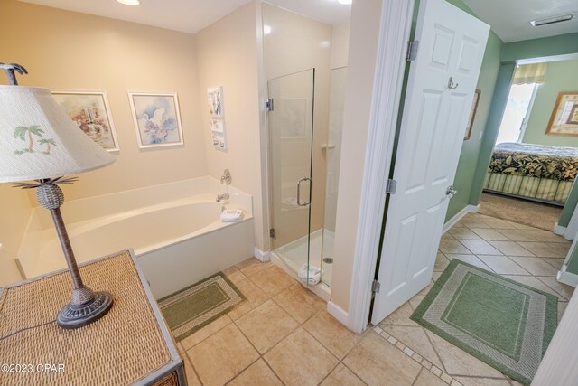 bathroom with shower with separate bathtub and tile patterned floors