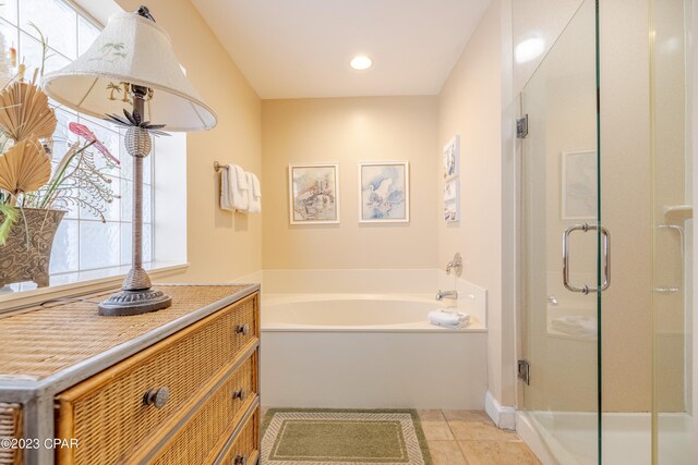 bathroom with tile patterned flooring, vanity, and separate shower and tub