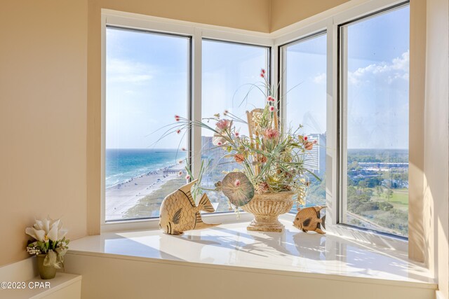 interior space with a view of the beach and a water view