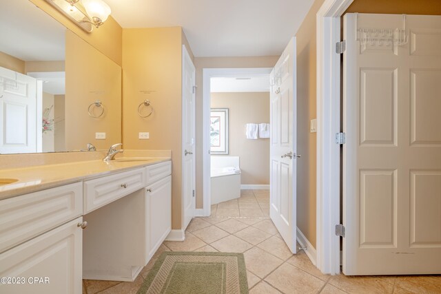 bathroom with tile patterned floors, a bath, and vanity