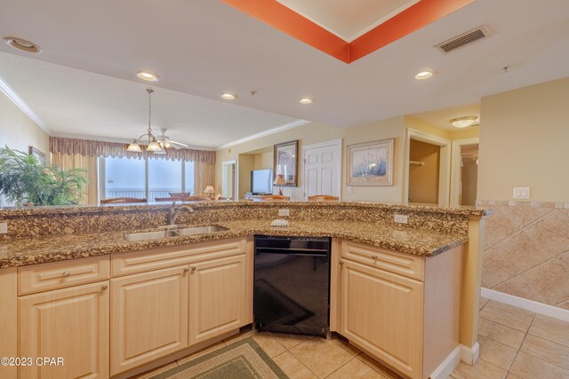 kitchen featuring light stone countertops, dishwasher, light tile patterned floors, and sink