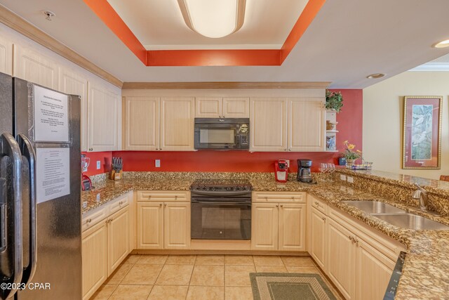 kitchen featuring light tile patterned flooring, kitchen peninsula, light stone countertops, black appliances, and sink