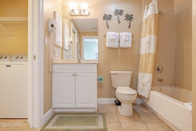 full bathroom featuring shower / bath combination with curtain, tile patterned flooring, vanity, washer and clothes dryer, and toilet