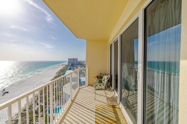 balcony with a view of the beach and a water view