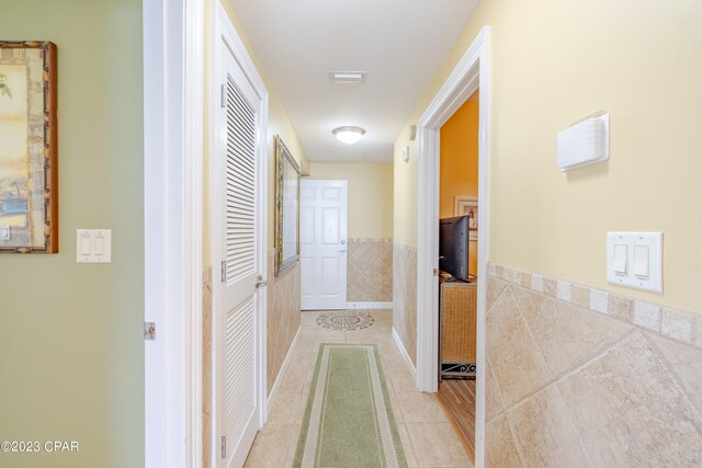 hall with light tile patterned floors