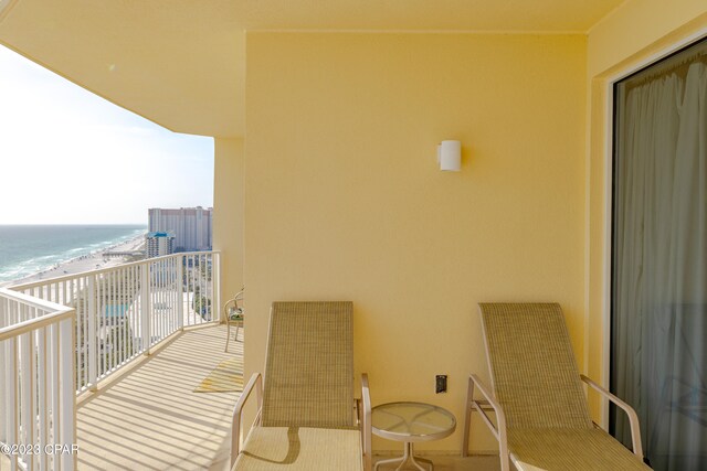 balcony with a view of the beach and a water view