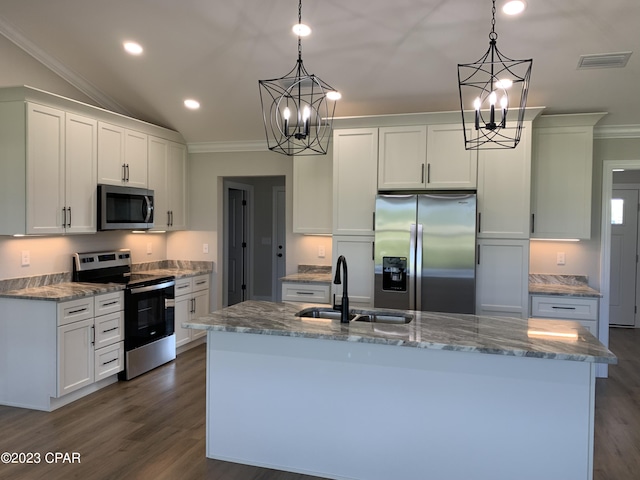 kitchen with white cabinets, decorative light fixtures, stainless steel appliances, sink, and a center island with sink