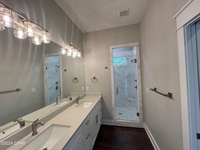 bathroom with vanity, hardwood / wood-style floors, and an enclosed shower