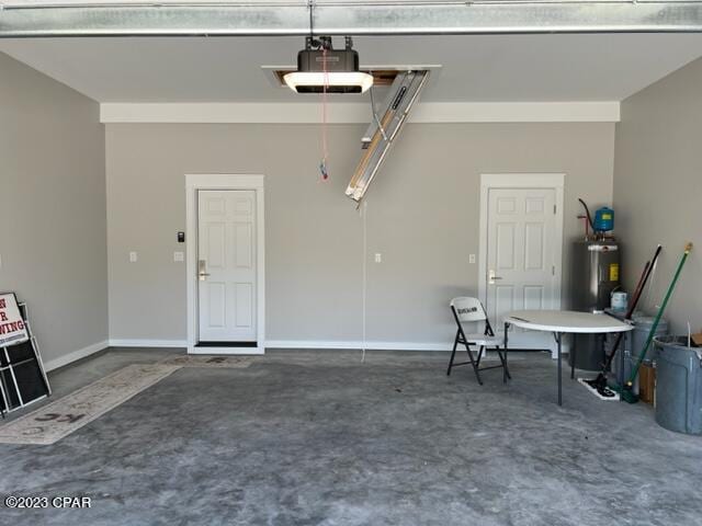 garage featuring a garage door opener and water heater