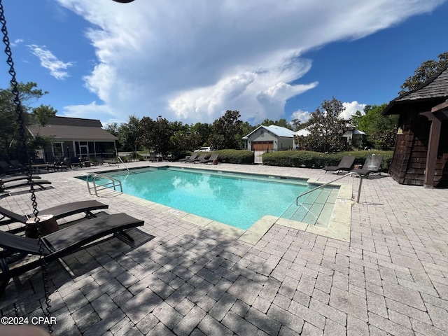 view of swimming pool featuring a patio