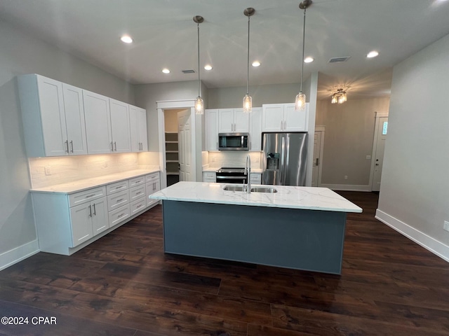 kitchen featuring white cabinetry, an island with sink, pendant lighting, stainless steel appliances, and dark hardwood / wood-style floors