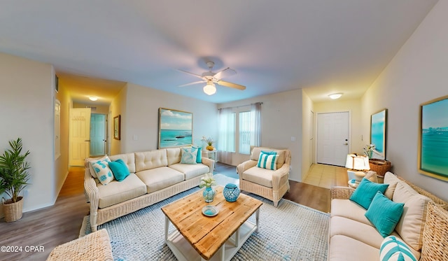 living room featuring light hardwood / wood-style flooring and ceiling fan