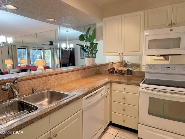 kitchen featuring white cabinets, a textured ceiling, sink, and white appliances