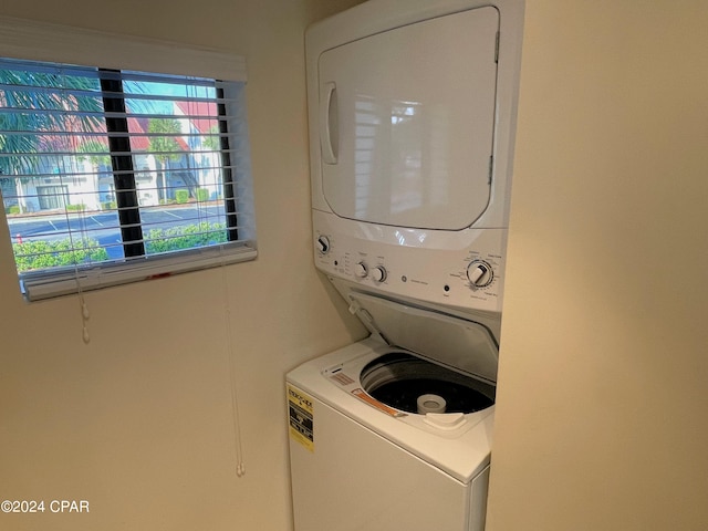 laundry room with stacked washer and dryer