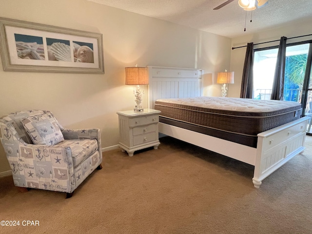 bedroom with dark colored carpet, ceiling fan, and a textured ceiling