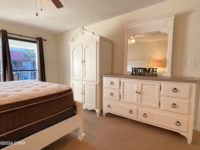 bedroom with dark carpet, a textured ceiling, and ceiling fan