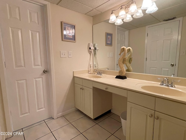 bathroom with vanity, a paneled ceiling, and tile patterned flooring