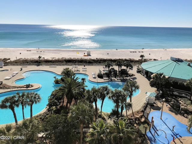 drone / aerial view featuring a view of the beach and a water view