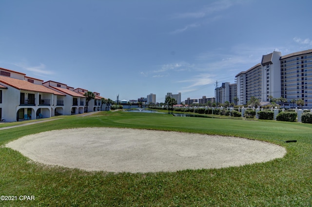 view of community featuring a yard and a water view